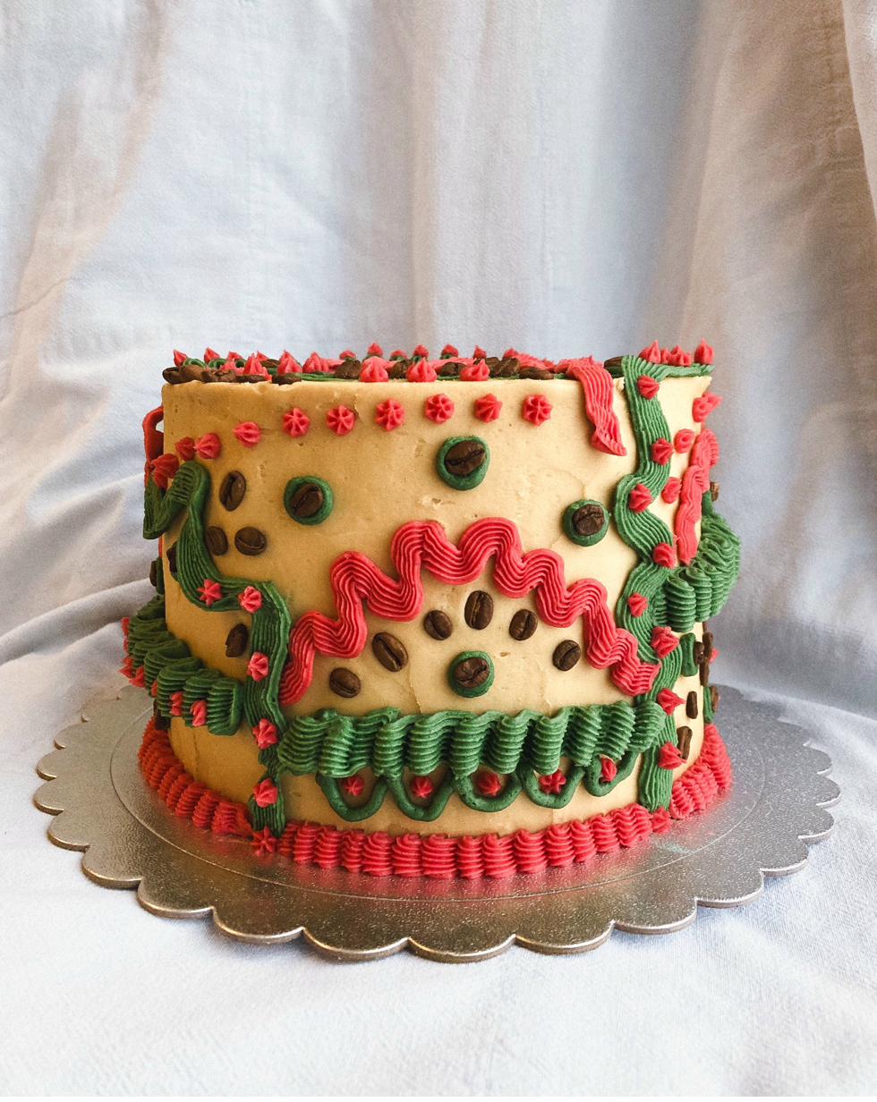 Celebration cake — pale blue buttercream with piped shell border and blueberry jam top