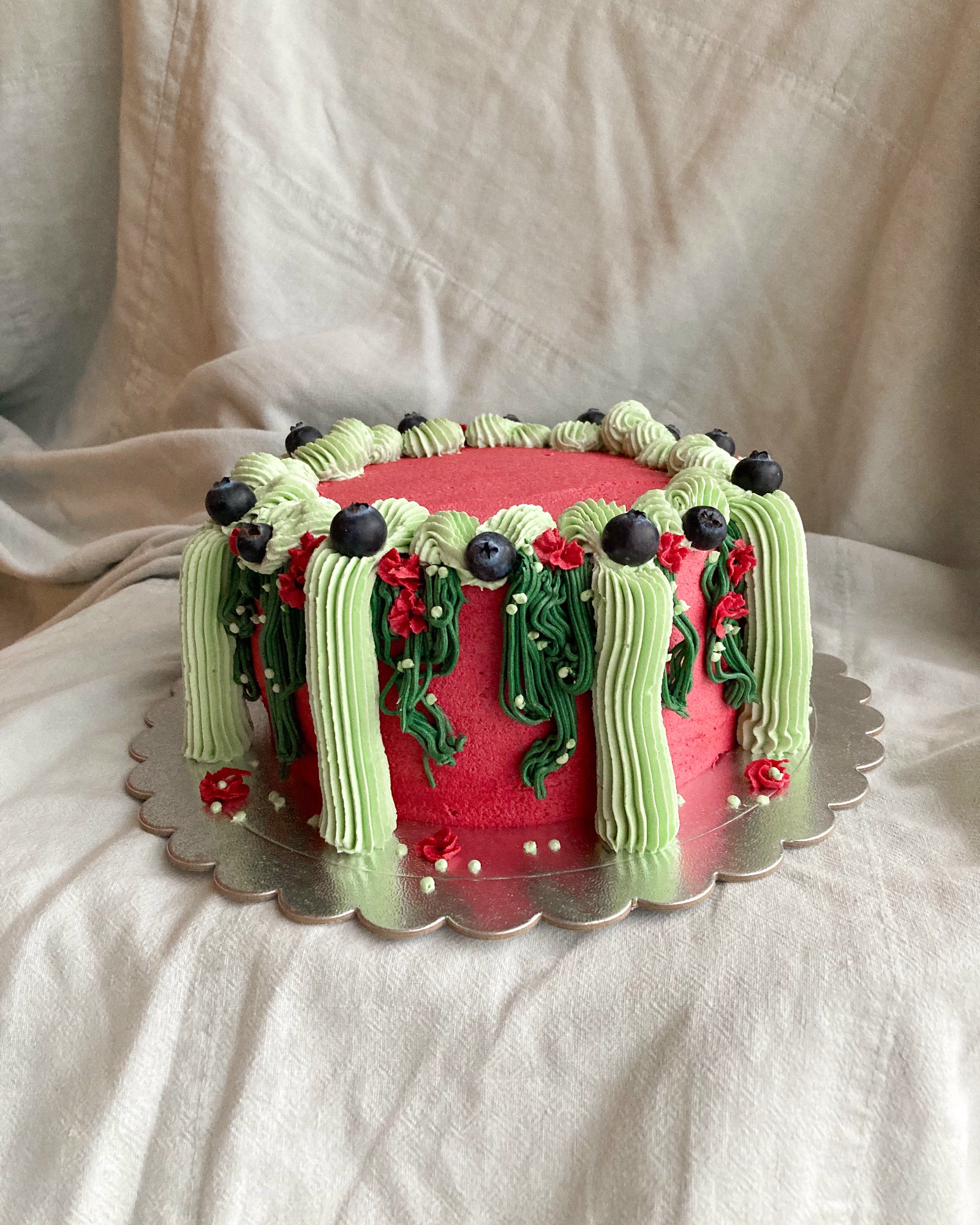 Celebration cake — sculpted landscape with crystal topper, green and purple piping with fresh herbs and berries