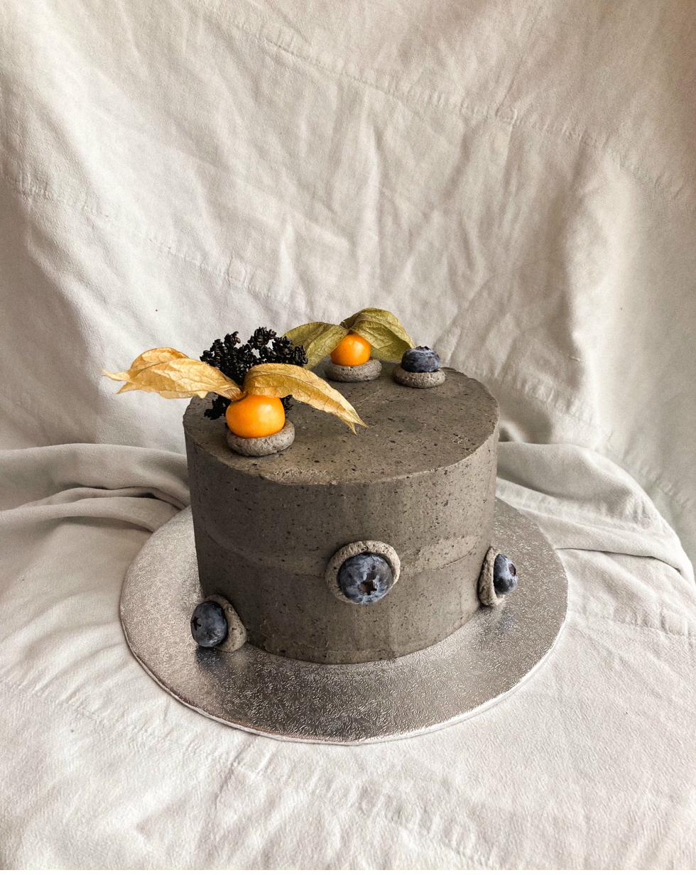 Celebration cake — square caramel buttercream base with red ruffled piping cube and cherry on top