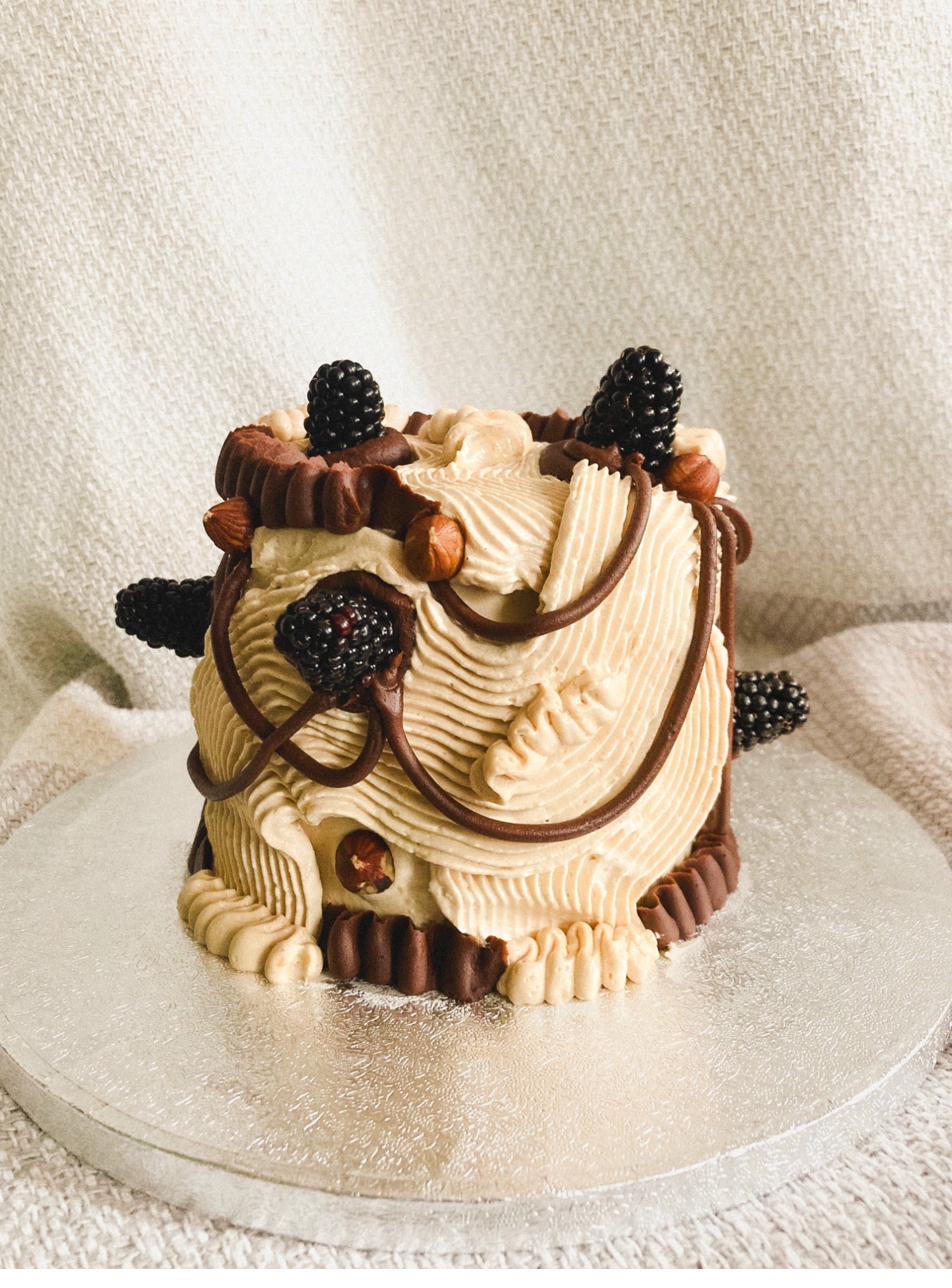 Celebration cake — peach and green yin-yang design with pistachio crumbs, blackberries and physalis