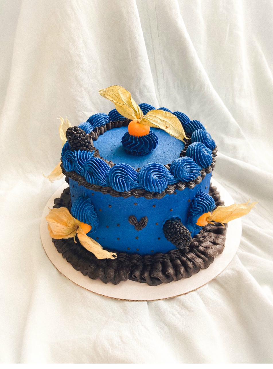 Celebration cake — hazelnut and blackberry cake with cream and chocolate piped waves