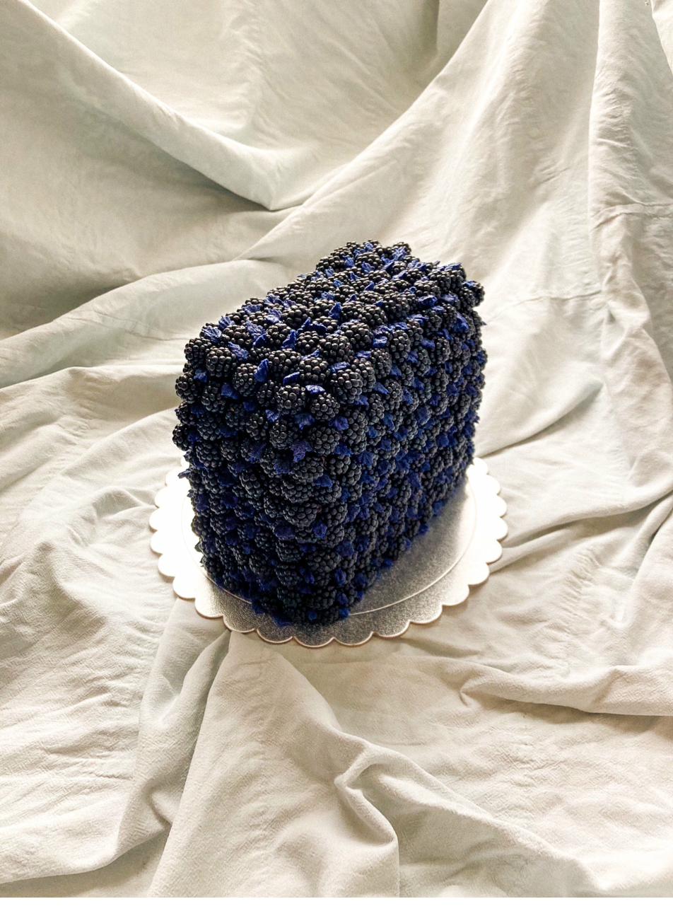 Celebration cake — teal and pink yin-yang design with blackberries and physalis